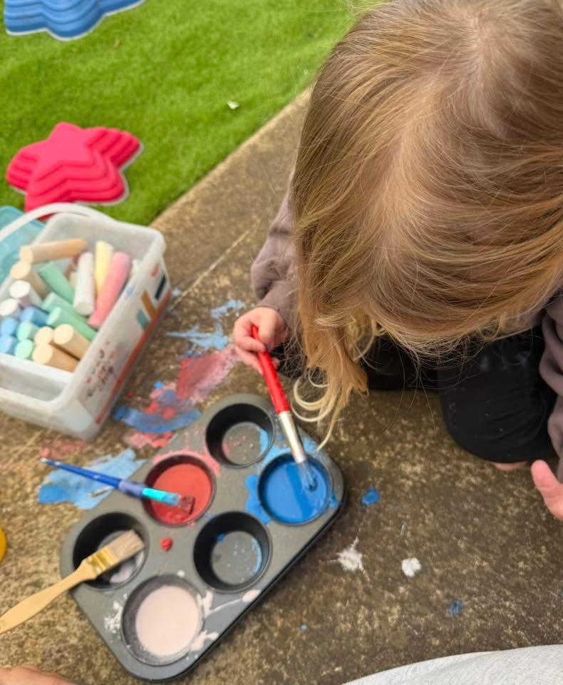 Mentor with a young person building confidence outdoors